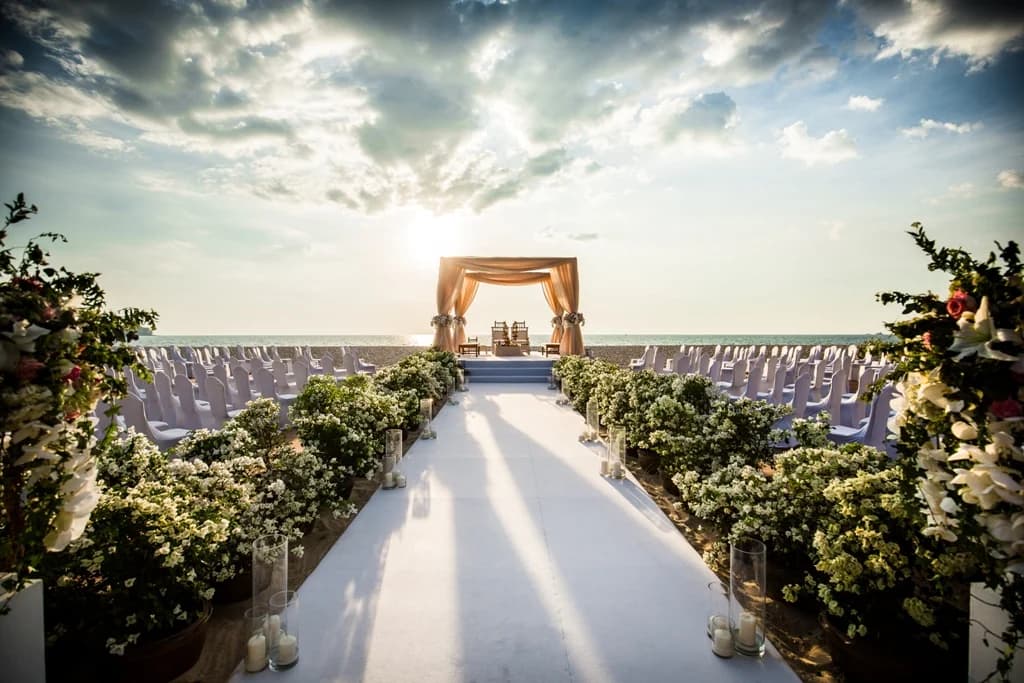 Beach wedding aisle leading to a sunset mandap at Angsana Laguna Phuket