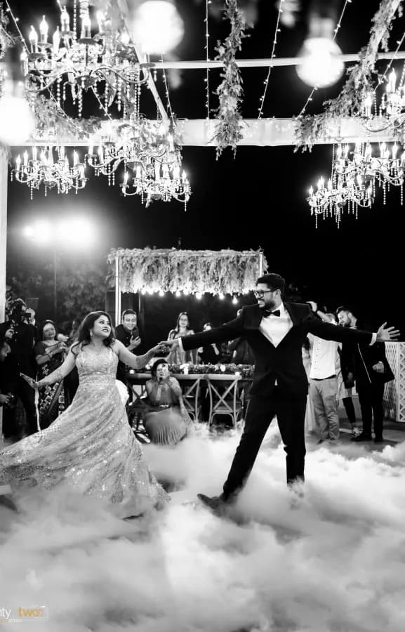 Couple first dance under chandeliers at a luxury Udaipur wedding