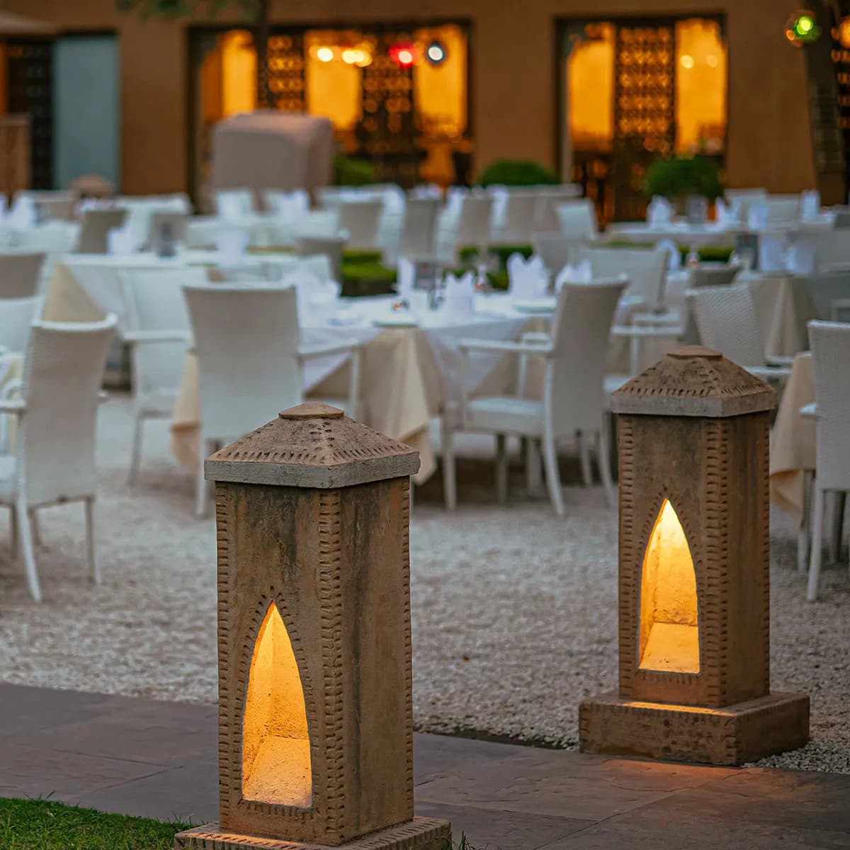 Lantern-lit outdoor garden dining setup at dusk at Ajit Bhawan Palace Jodhpur