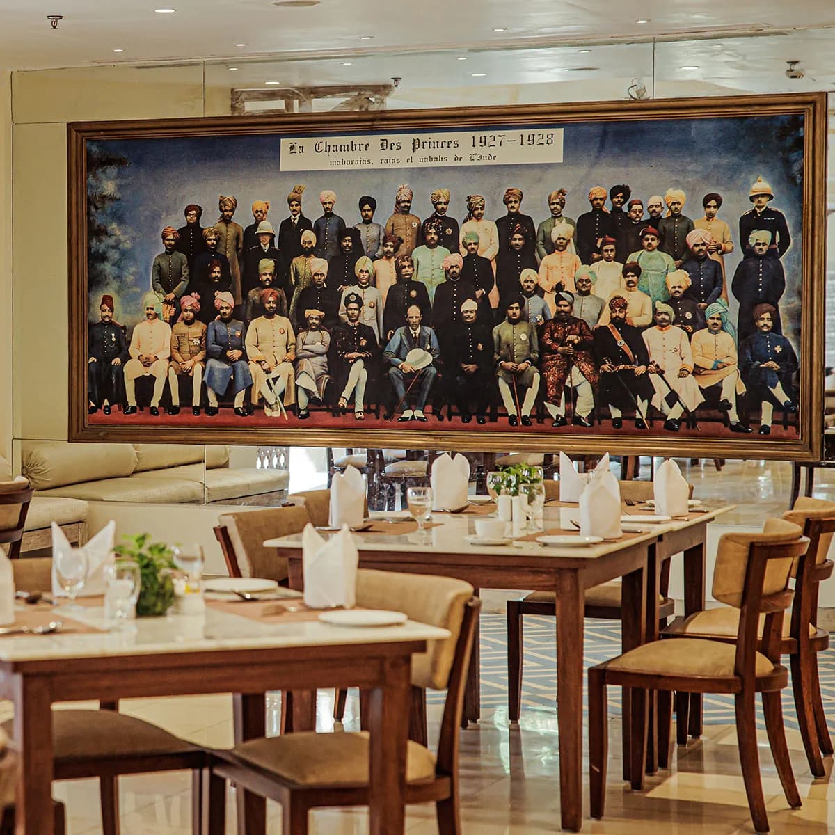 Heritage restaurant dining beneath a royal Marwar group portrait at Ajit Bhawan Palace Jodhpur