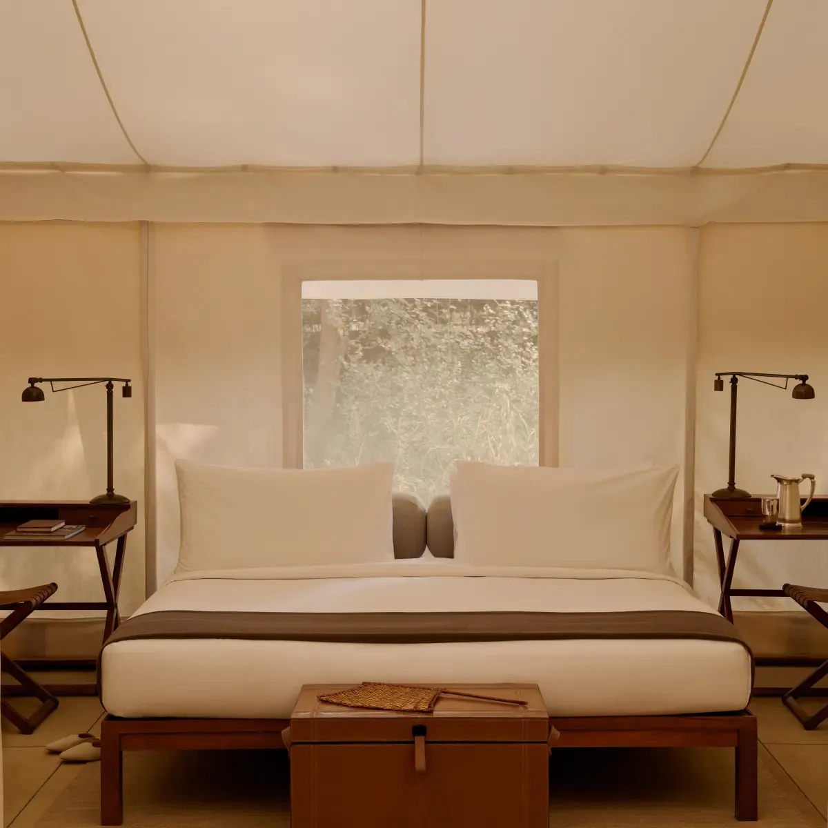 Soaring cream tented pavilion bedroom interior with elegant furnishings at Aman-i-Khas Ranthambore