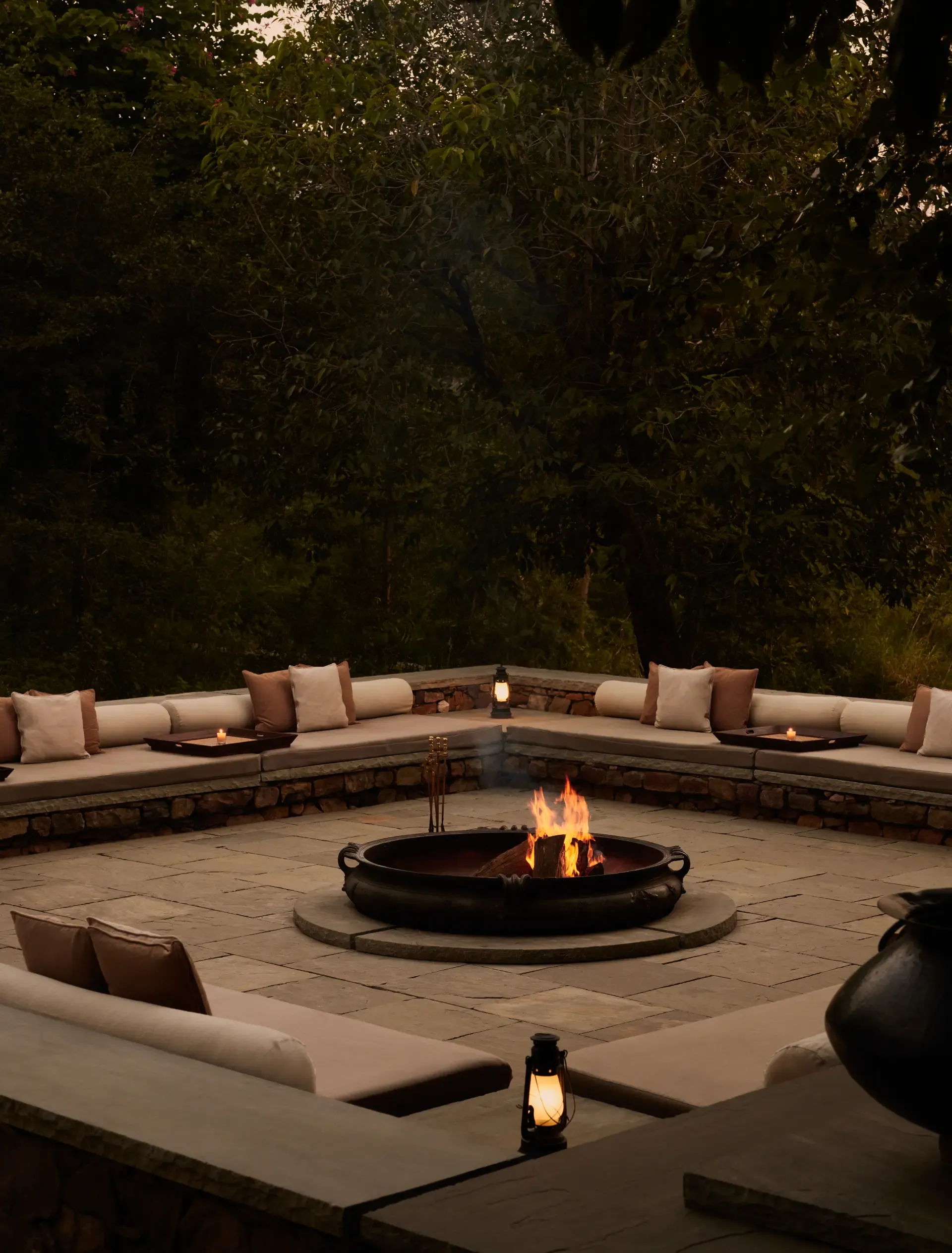 Symmetrical Mughal dining pavilion with a central fire pit lit at dusk at Aman-i-Khas Ranthambore
