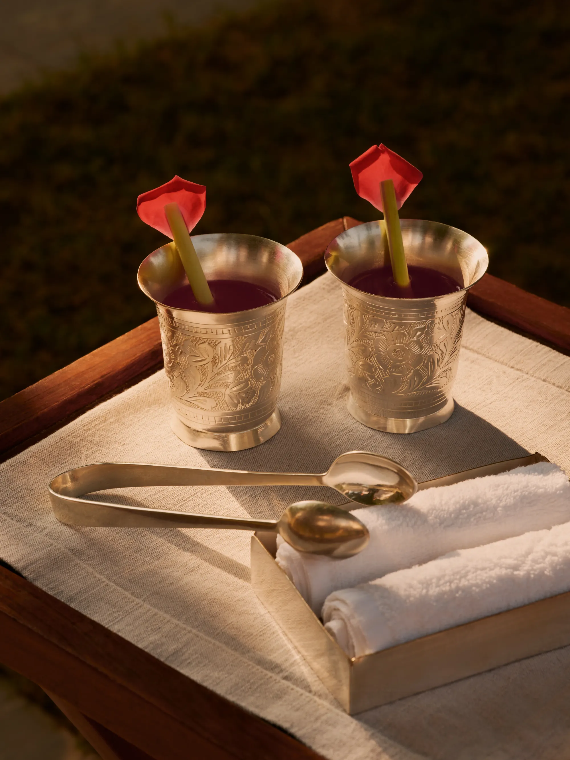 Welcome drinks served in gold vessels with red roses at Aman-i-Khas Ranthambore