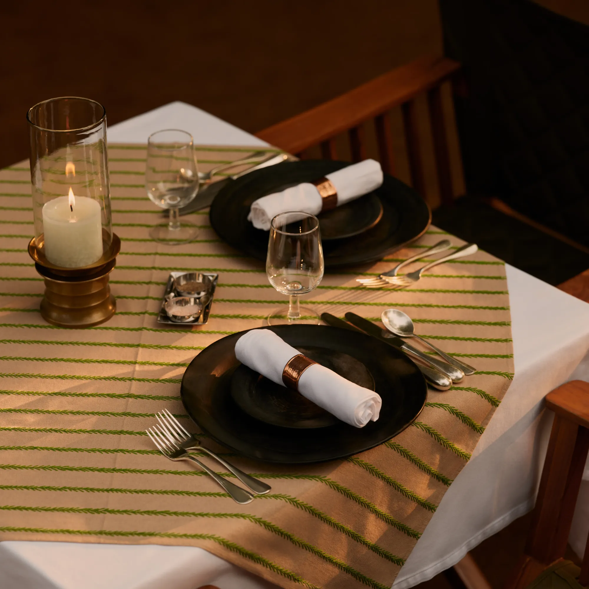 Private candlelit dining table set in the jungle wilderness at Aman-i-Khas Ranthambore