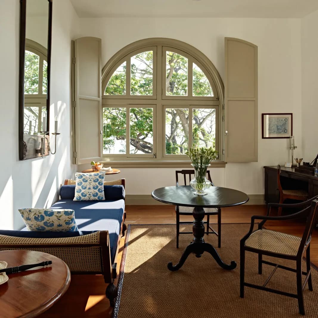 Sunlit Amangalla suite with arched windows and garden views, Galle Fort Sri Lanka