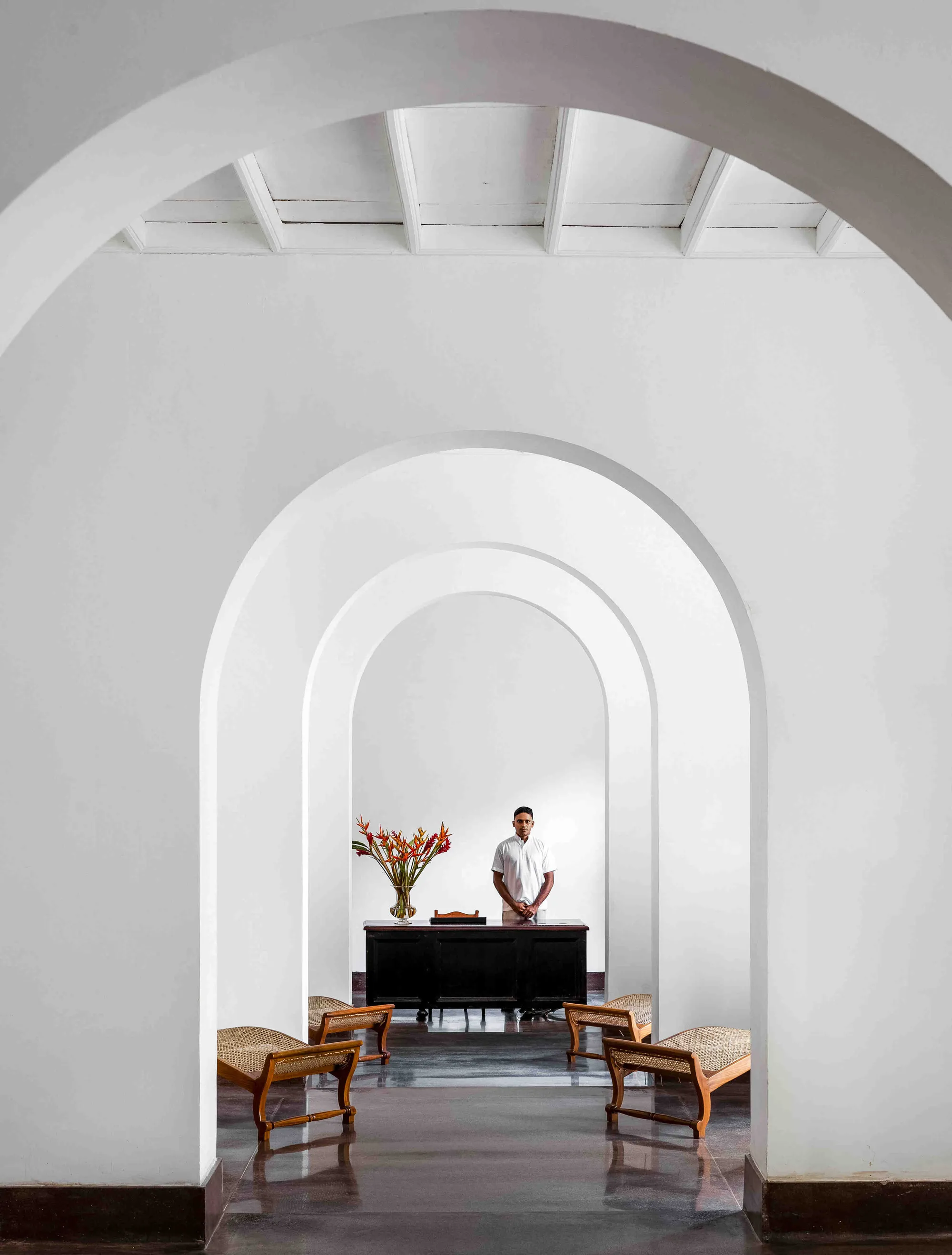 Vaulted colonial corridor with grand piano at Amangalla Galle Fort