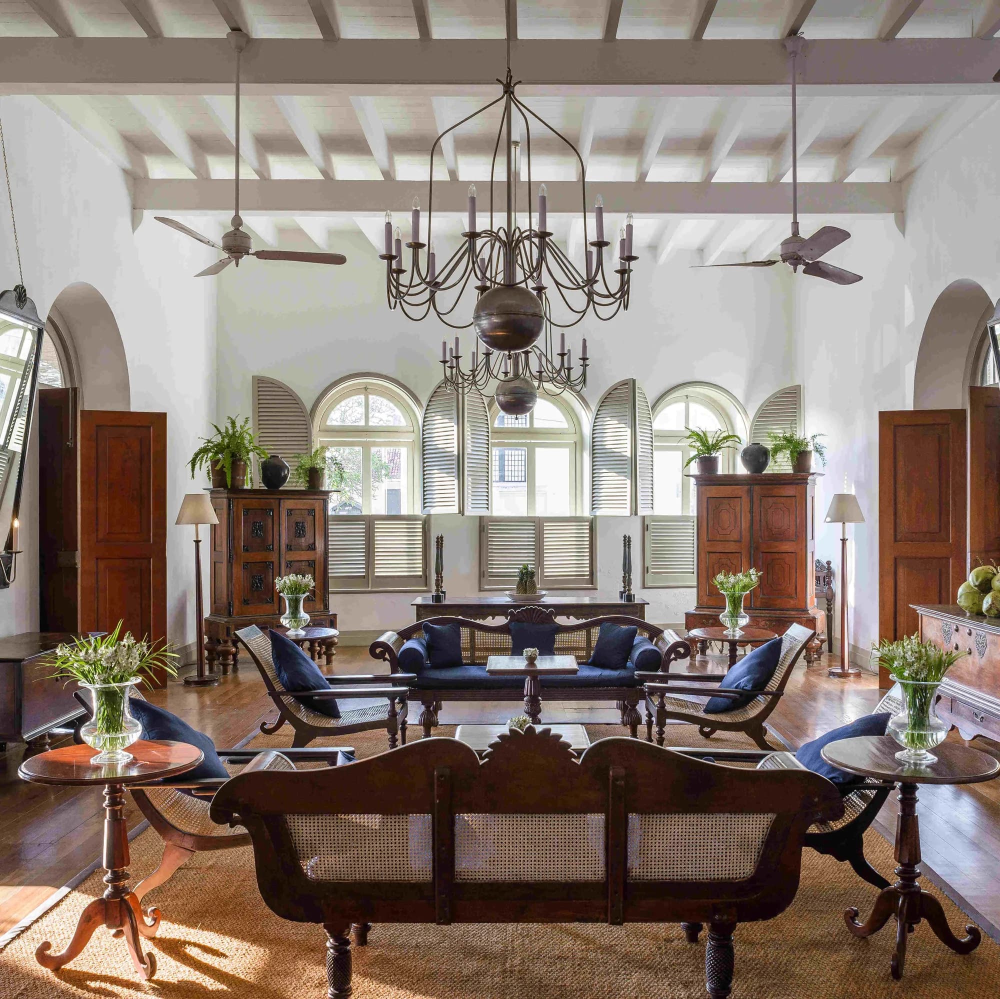 Light-filled colonnaded Zaal heritage lounge with chandelier at Amangalla Galle