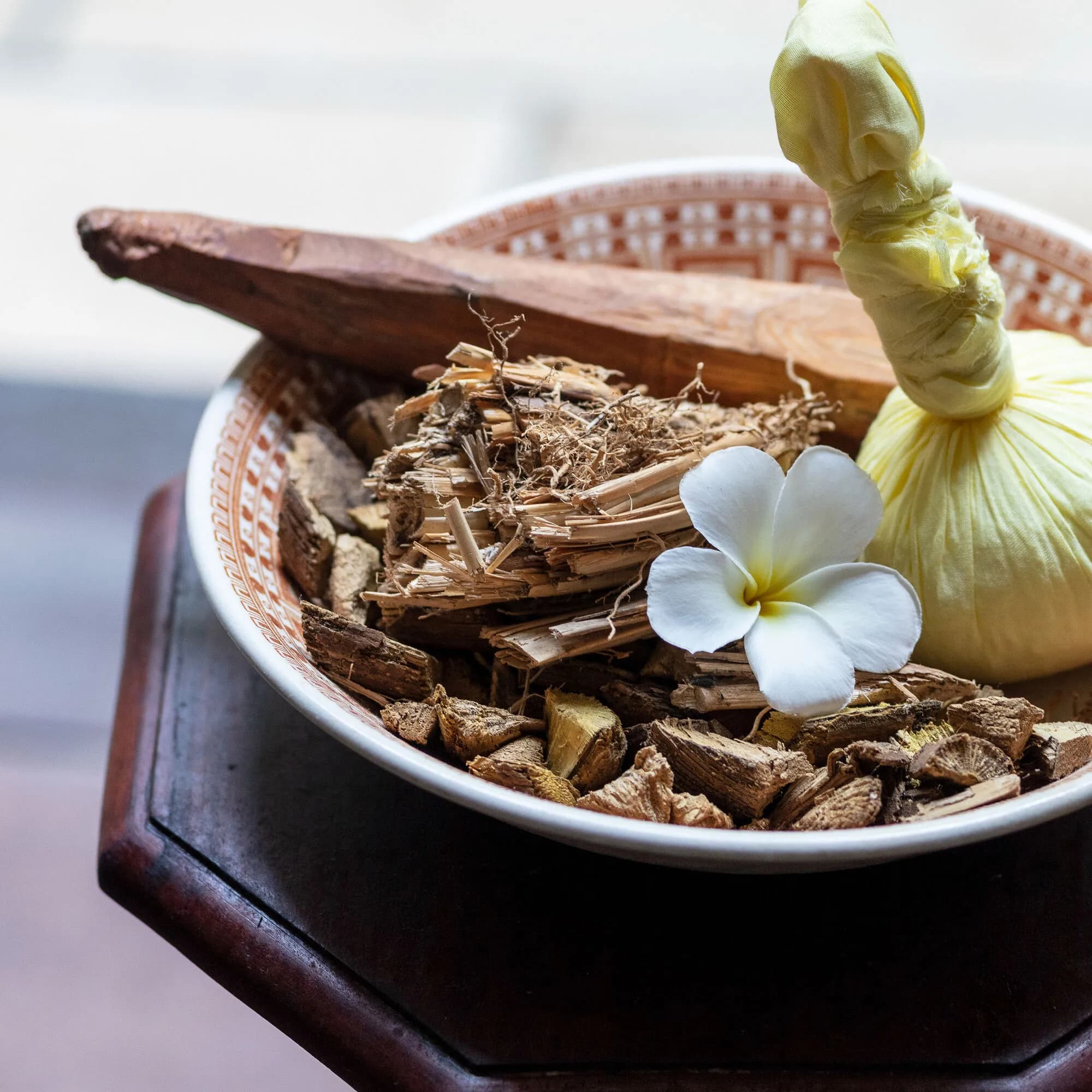 Carved wooden ornaments and floral arrangement detail at Amangalla Galle