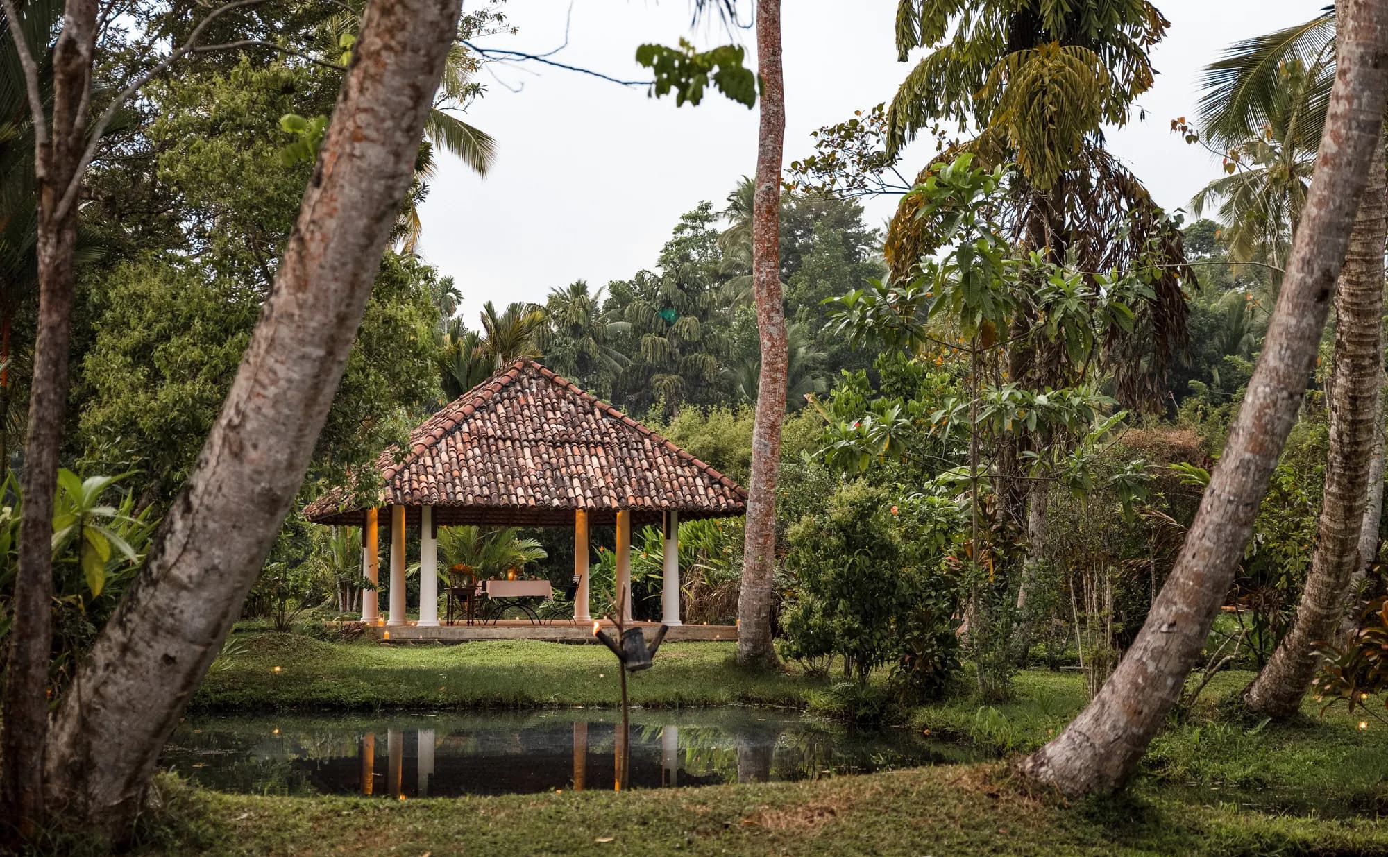 Wooden colonial pavilion set among garden trees at Amangalla Galle Fort