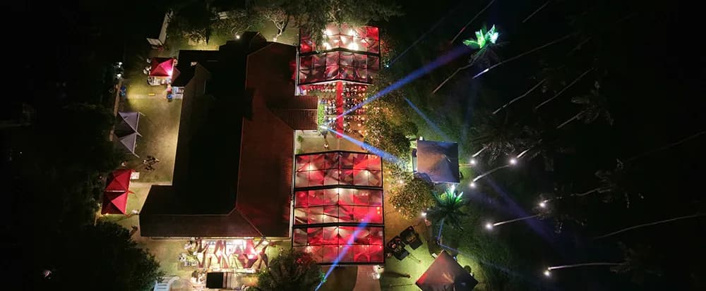 Aerial of illuminated event marquees and stage lighting on the clifftop at Anantara Peace Haven Tangalle Sri Lanka