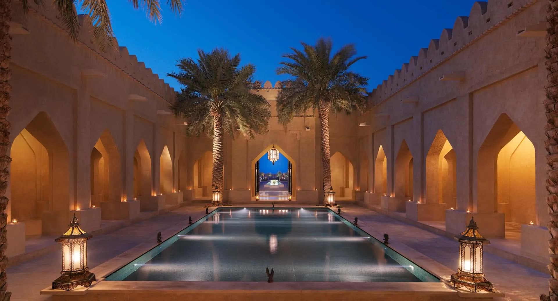 Lantern-lit arrival courtyard of Anantara Qasr Al Sarab Desert Resort at night, Liwa, Abu Dhabi