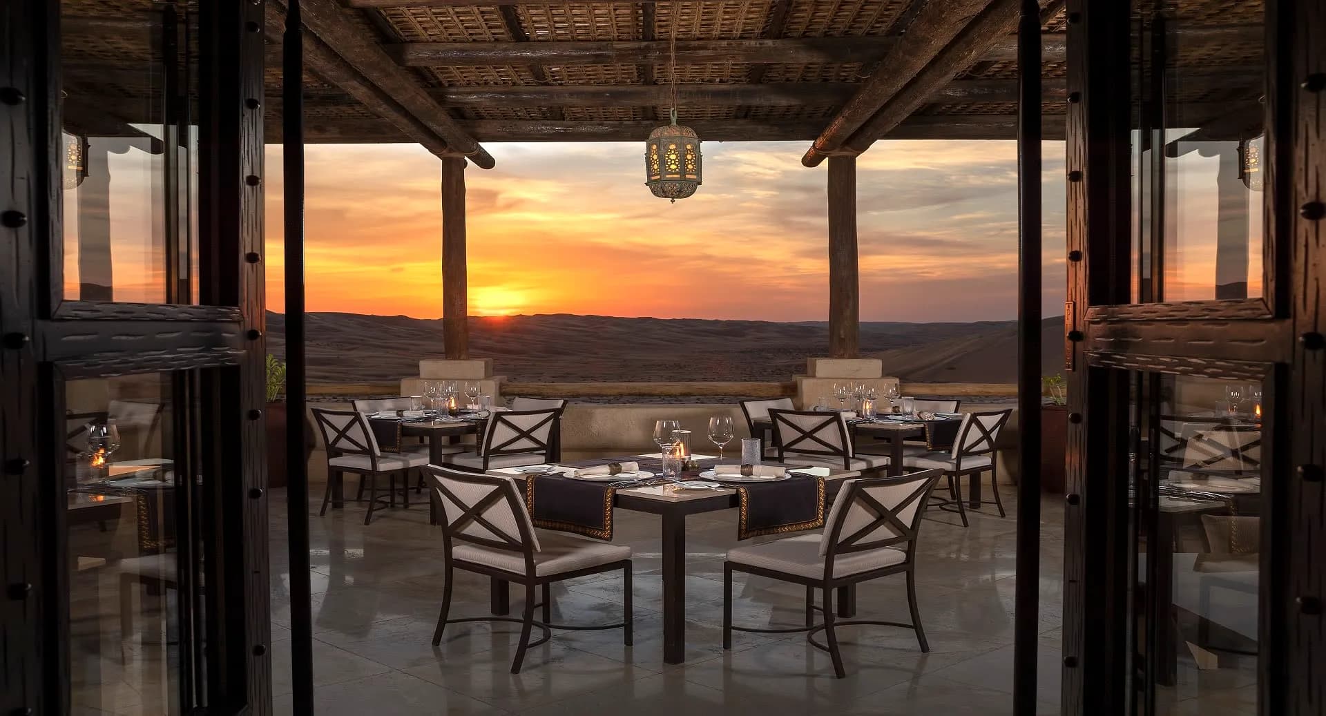 Suhail restaurant outdoor terrace dining at sunset above the dunes at Anantara Qasr Al Sarab, Abu Dhabi
