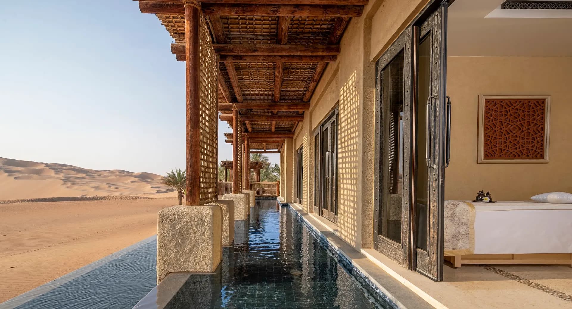 Anantara Qasr Al Sarab Desert Resort fortress glowing above the Empty Quarter dunes at dusk, Abu Dhabi