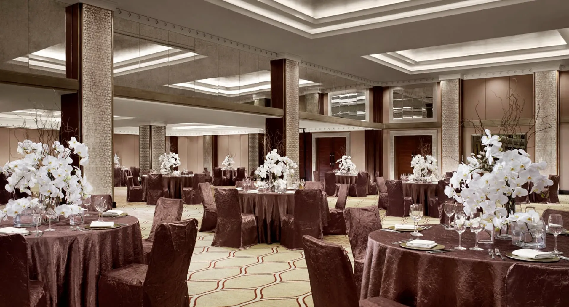 Chaophraya Ballroom set with round tables for a large banquet reception at Anantara Riverside Bangkok Resort