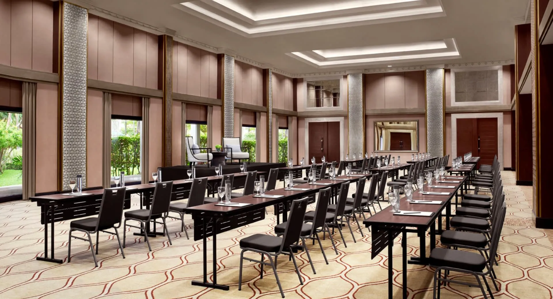 Chaophraya Ballroom set with round tables and stage lighting for a sangeet at Anantara Riverside Bangkok Resort