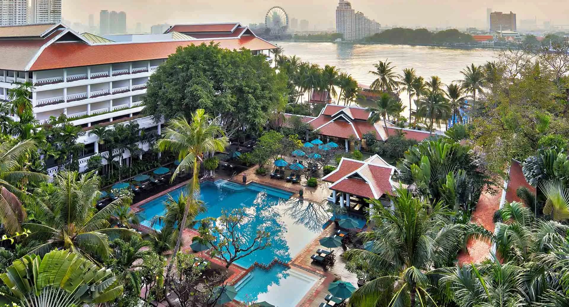 Aerial view of the riverside pool and the Chao Phraya River at golden hour, Anantara Riverside Bangkok Resort