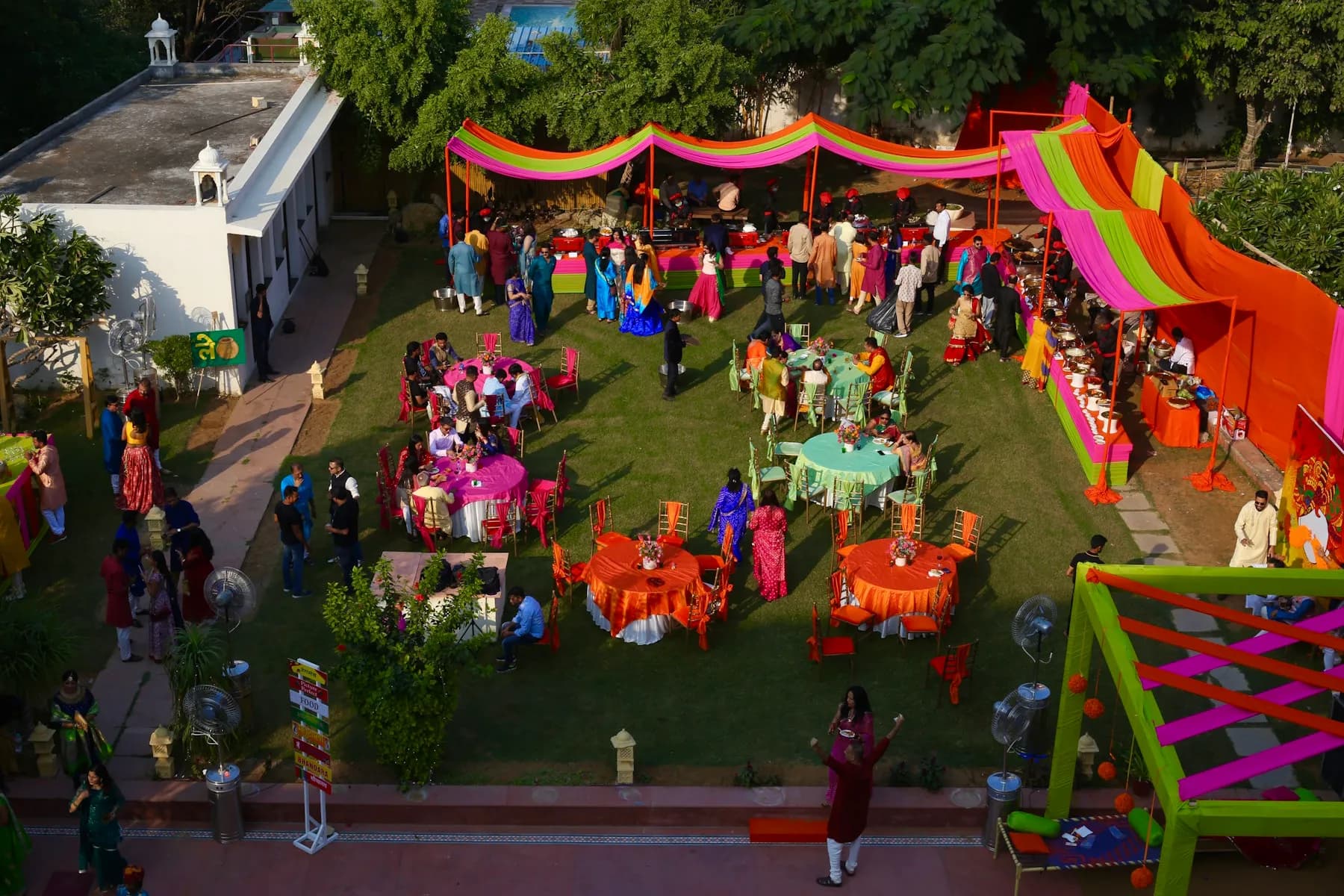 All-white Rajasthani haveli facade and carved arches of Anuraga Palace Ranthambore above green lawns