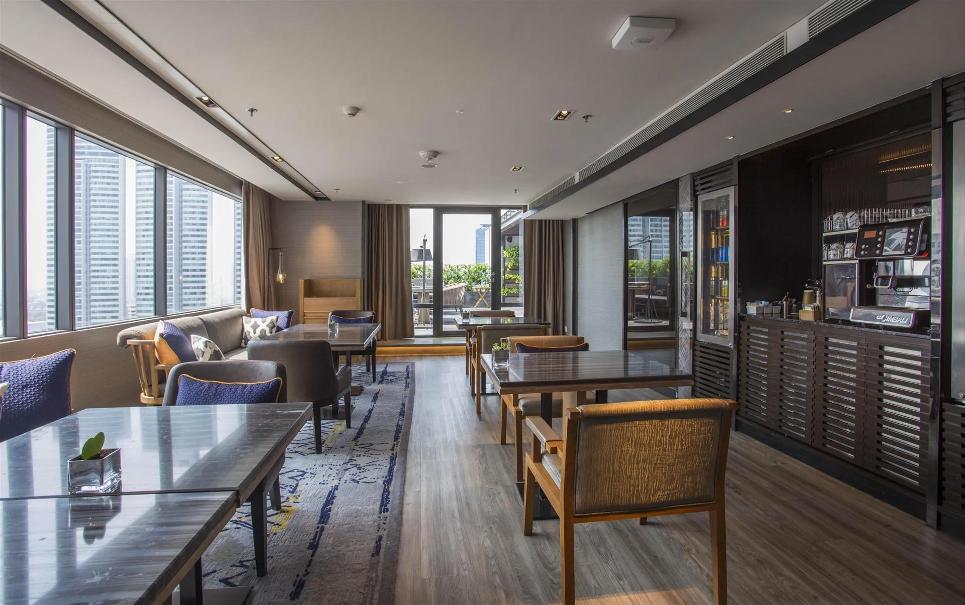 Executive club lounge with floor-to-ceiling windows and Bangkok city views at Bangkok Marriott Marquis Queen's Park