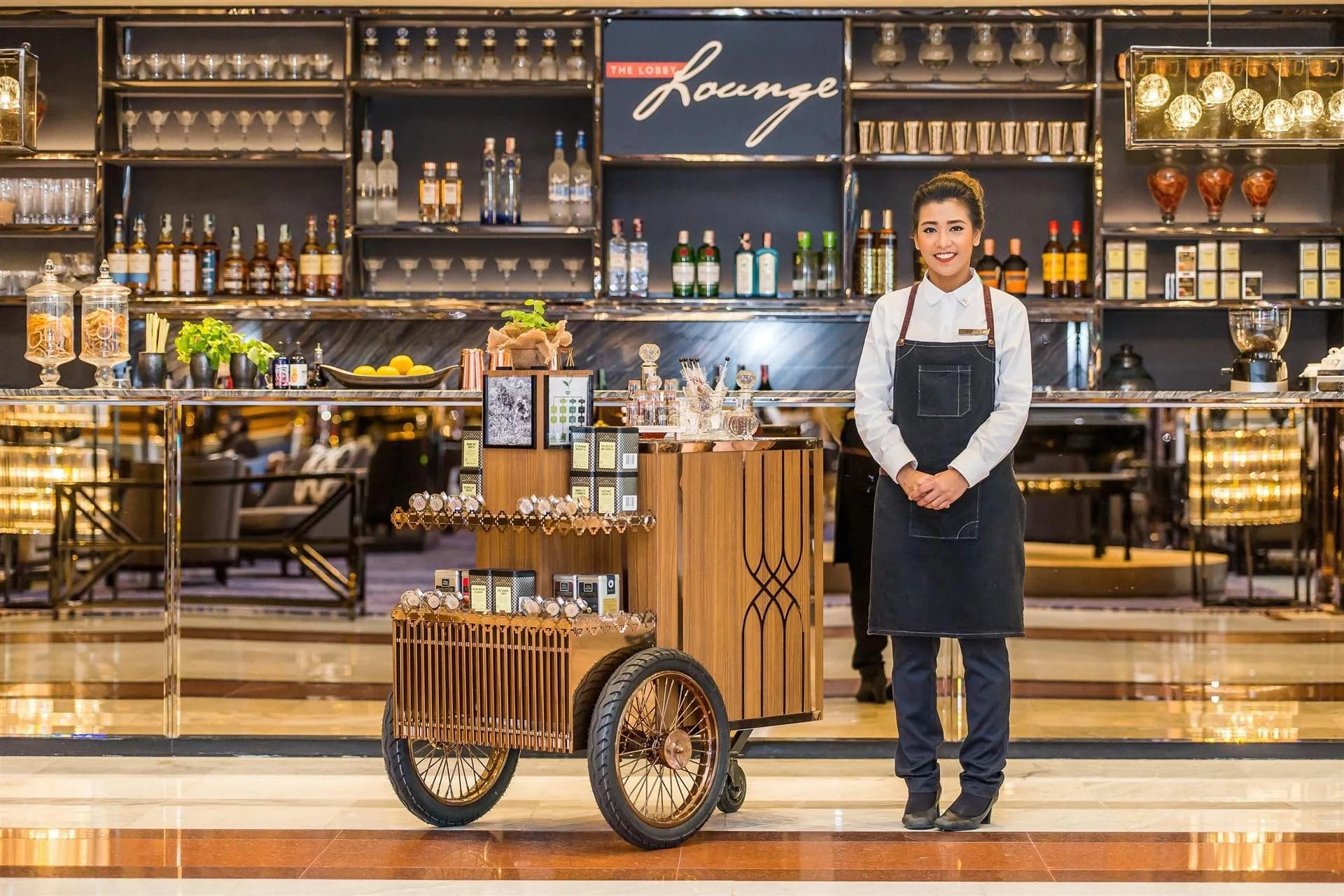 Lobby lounge bar with a signature coffee cart and host at Bangkok Marriott Marquis Queen's Park