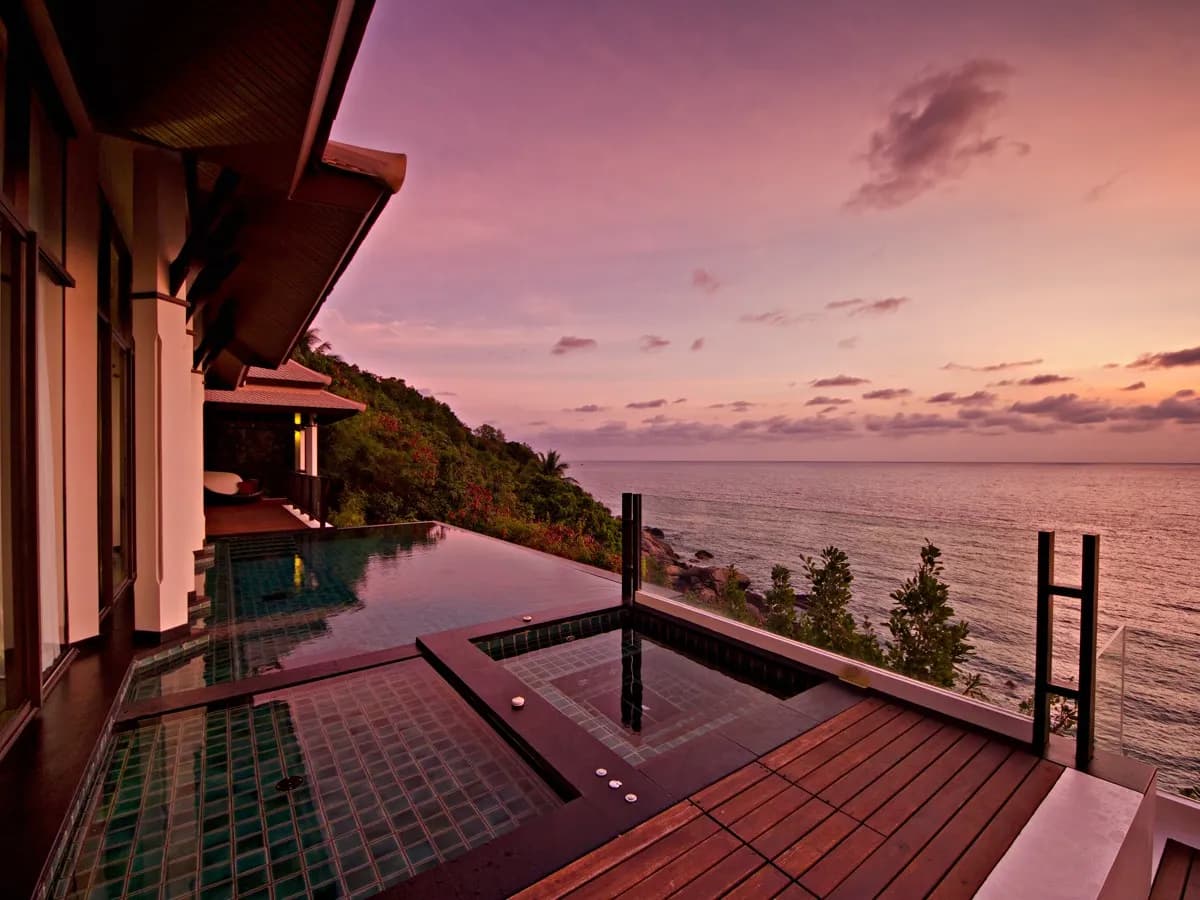 Clifftop villa infinity pool and deck overlooking the Gulf of Thailand at sunset, Banyan Tree Samui