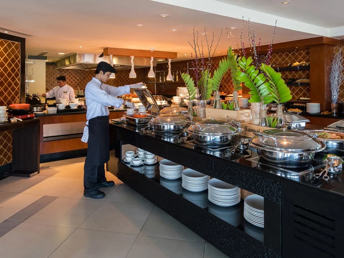 Chef tending a live buffet with tropical floral styling at Banyan Tree Samui, Koh Samui