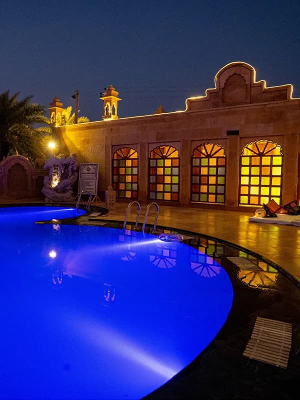 Poolside lawn and Rajasthani-themed central courtyard at Chokhi Dhani The Palace Hotel