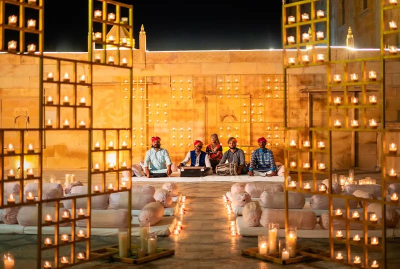 Evening sangeet with Rajasthani folk performers on the lit lawn at Chokhi Dhani The Palace Hotel