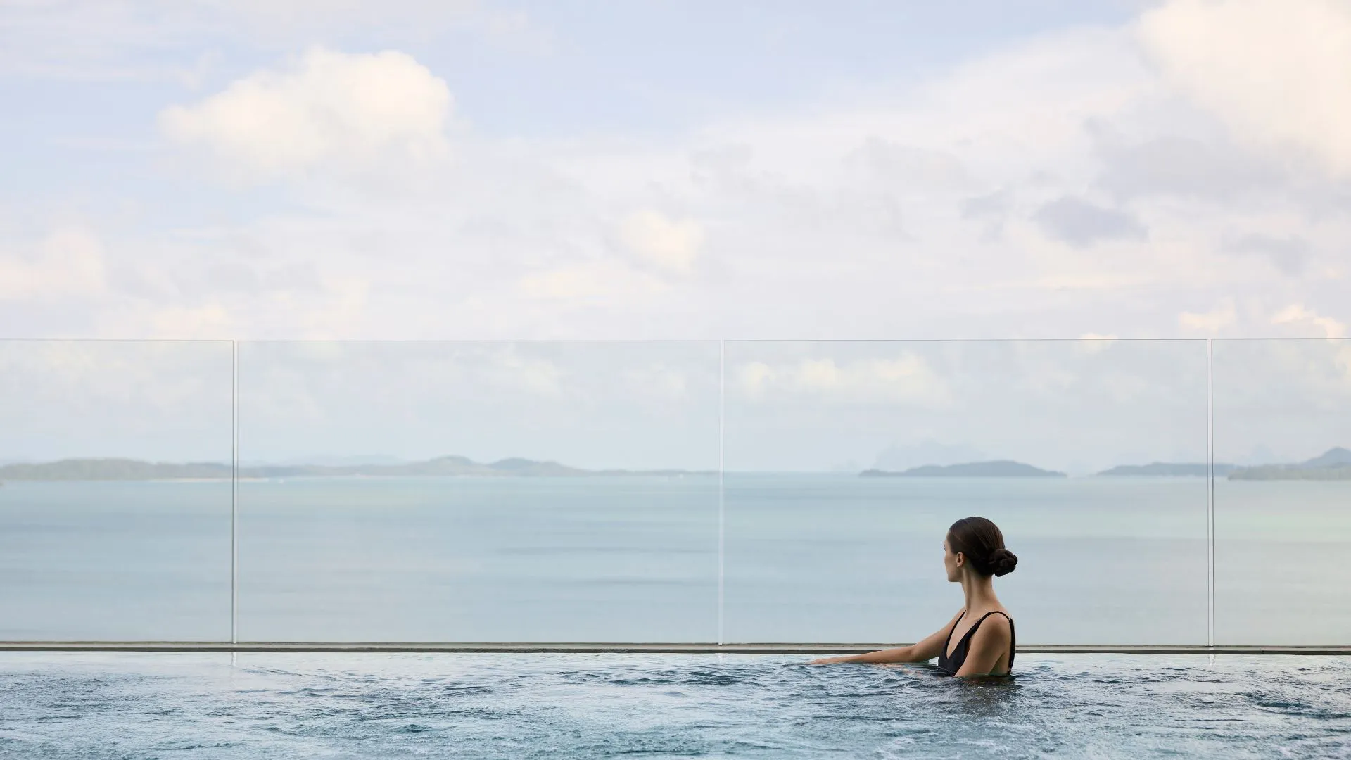Clifftop infinity pool of COMO Point Yamu Phuket reaching toward the limestone karsts of Phang Nga Bay