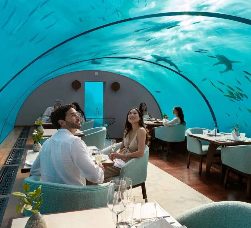 Intimate couple's private dinner inside the Ithaa undersea restaurant at Conrad Maldives Rangali Island