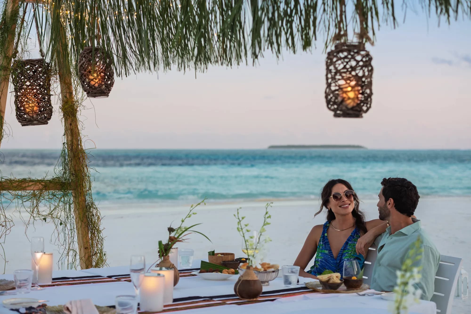 Private beach dining for two at golden hour on the sand at Conrad Maldives Rangali Island