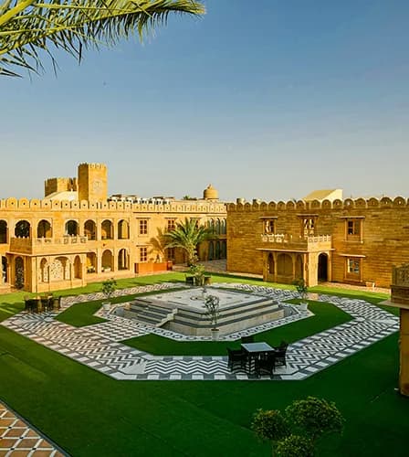 Swimming pool and carved sandstone central courtyard at Fort Rajwada Jaisalmer