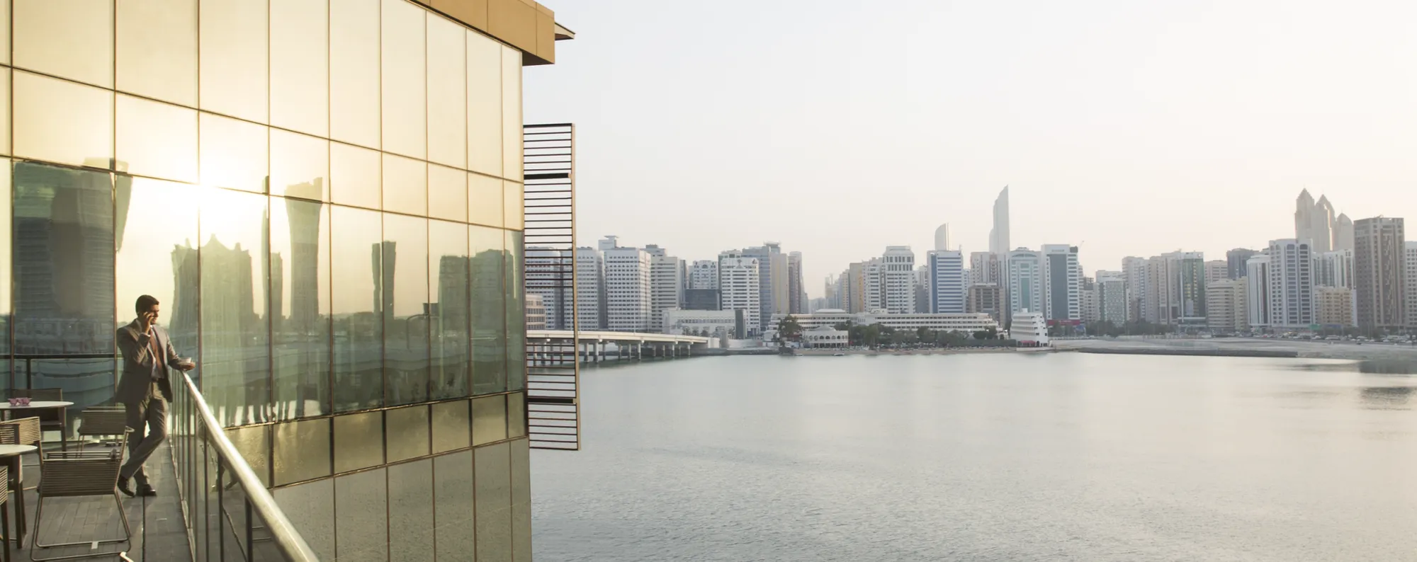 Waterfront terrace over the marina with Abu Dhabi skyline at golden hour at Four Seasons Abu Dhabi