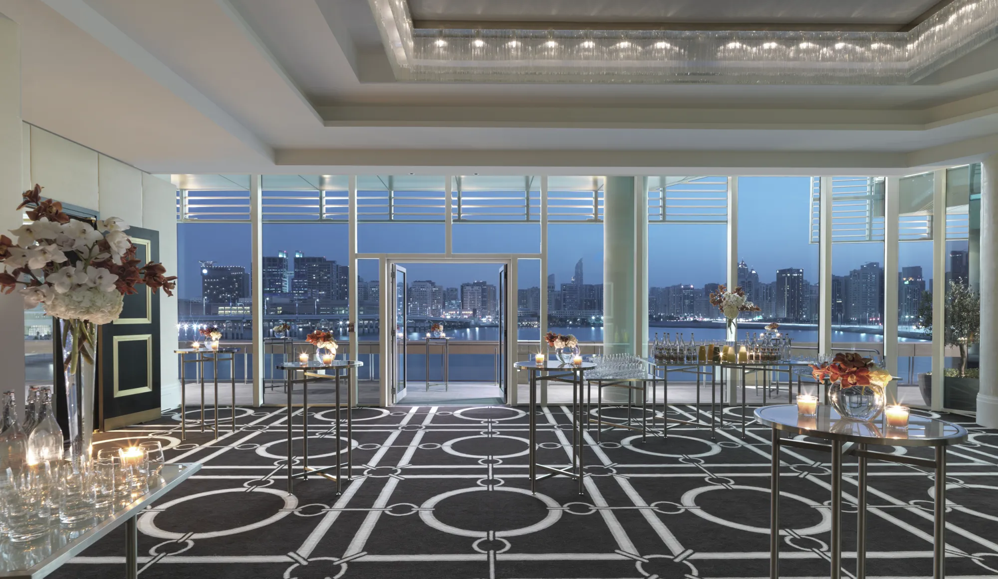 Pre-function reception space with floor-to-ceiling windows and Abu Dhabi skyline at Four Seasons Abu Dhabi