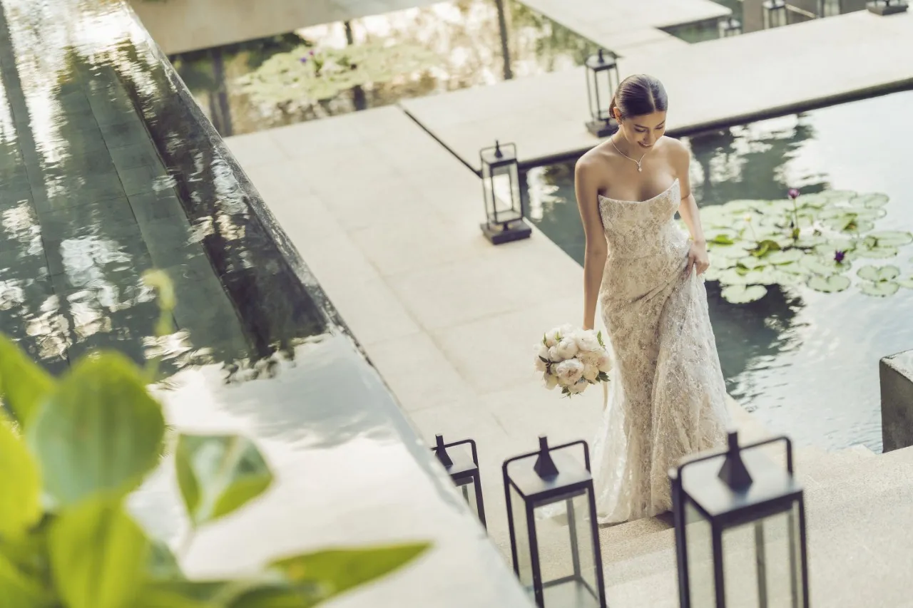 Bride descending the lantern-lined water-garden steps at Four Seasons Hotel Bangkok at Chao Phraya River