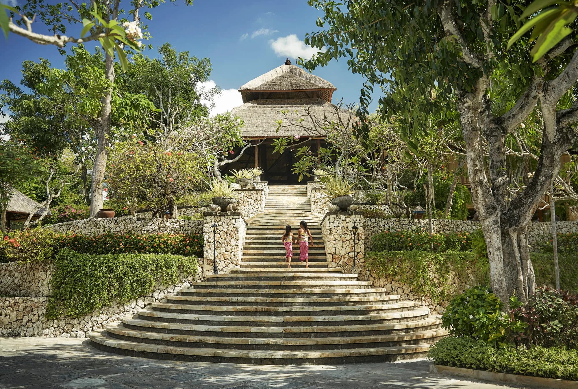 Four Seasons Resort Bali at Jimbaran Bay ocean-edge garden lawn ceremony setting above Jimbaran Bay