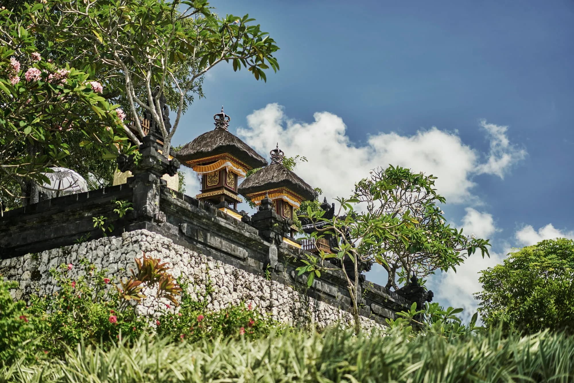 Four Seasons Resort Bali at Jimbaran Bay ocean-edge garden lawn set for a wedding reception dinner above Jimbaran Bay