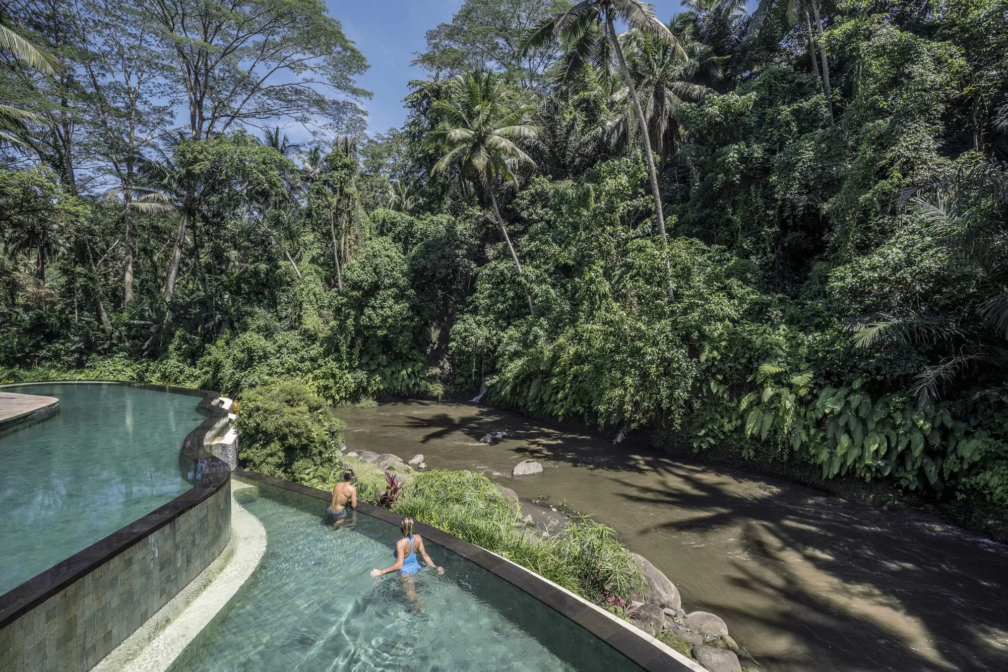 Open-air Ayung Terrace restaurant set for a seated dinner at Four Seasons Resort Bali at Sayan Ubud Bali