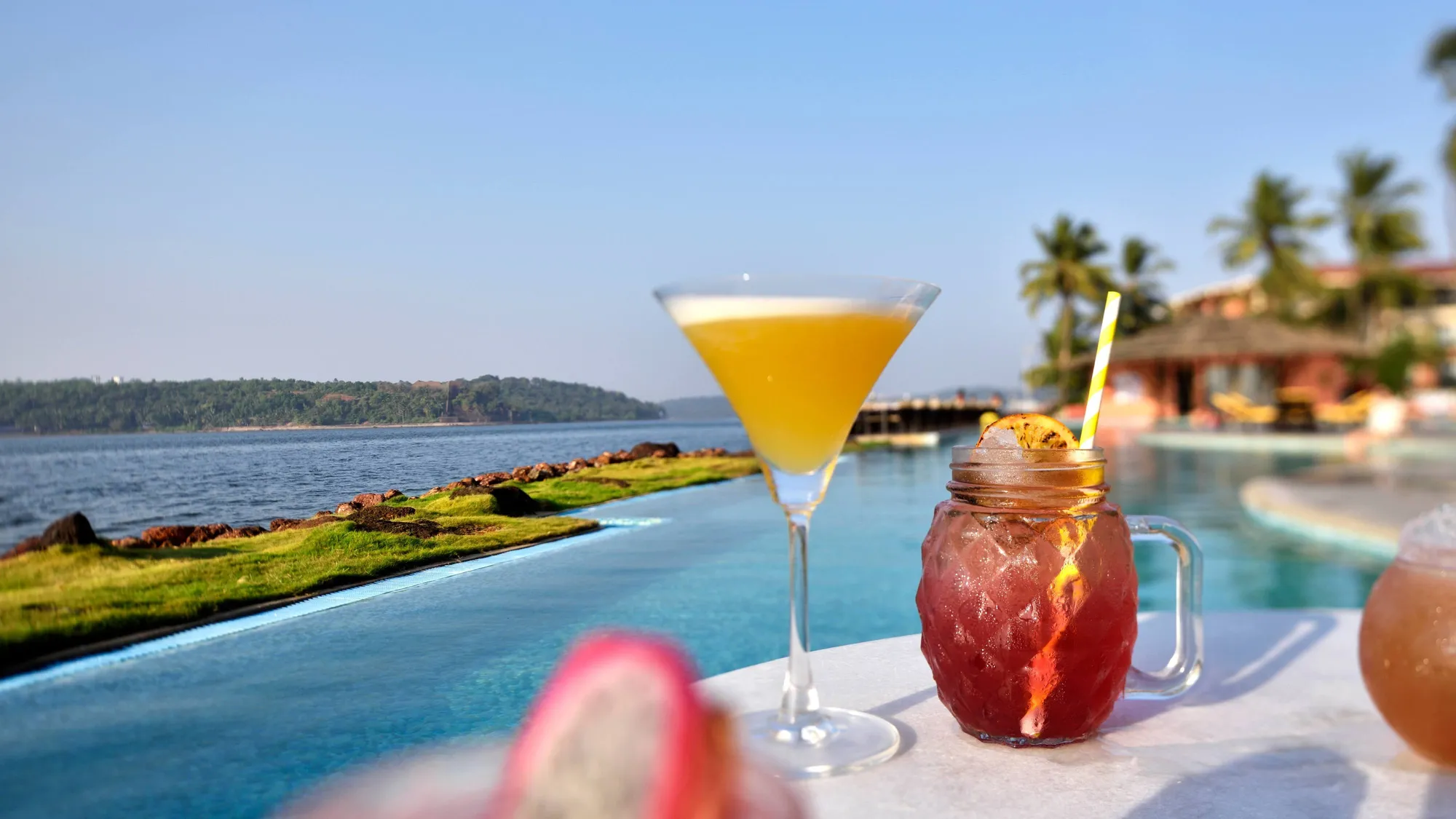 Outdoor swimming pool overlooking Miramar bay at Goa Marriott Resort and Spa