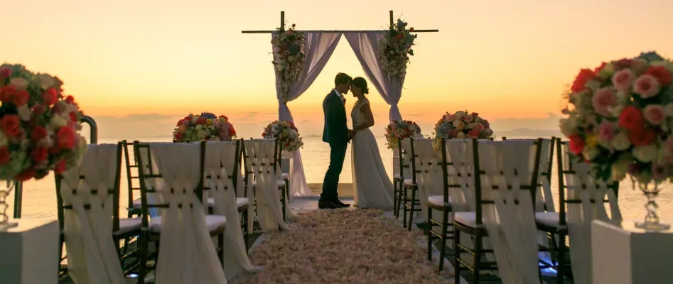 Sunset wedding ceremony on the private overwater pier, Asia's longest wedding aisle, at InterContinental Koh Samui Resort