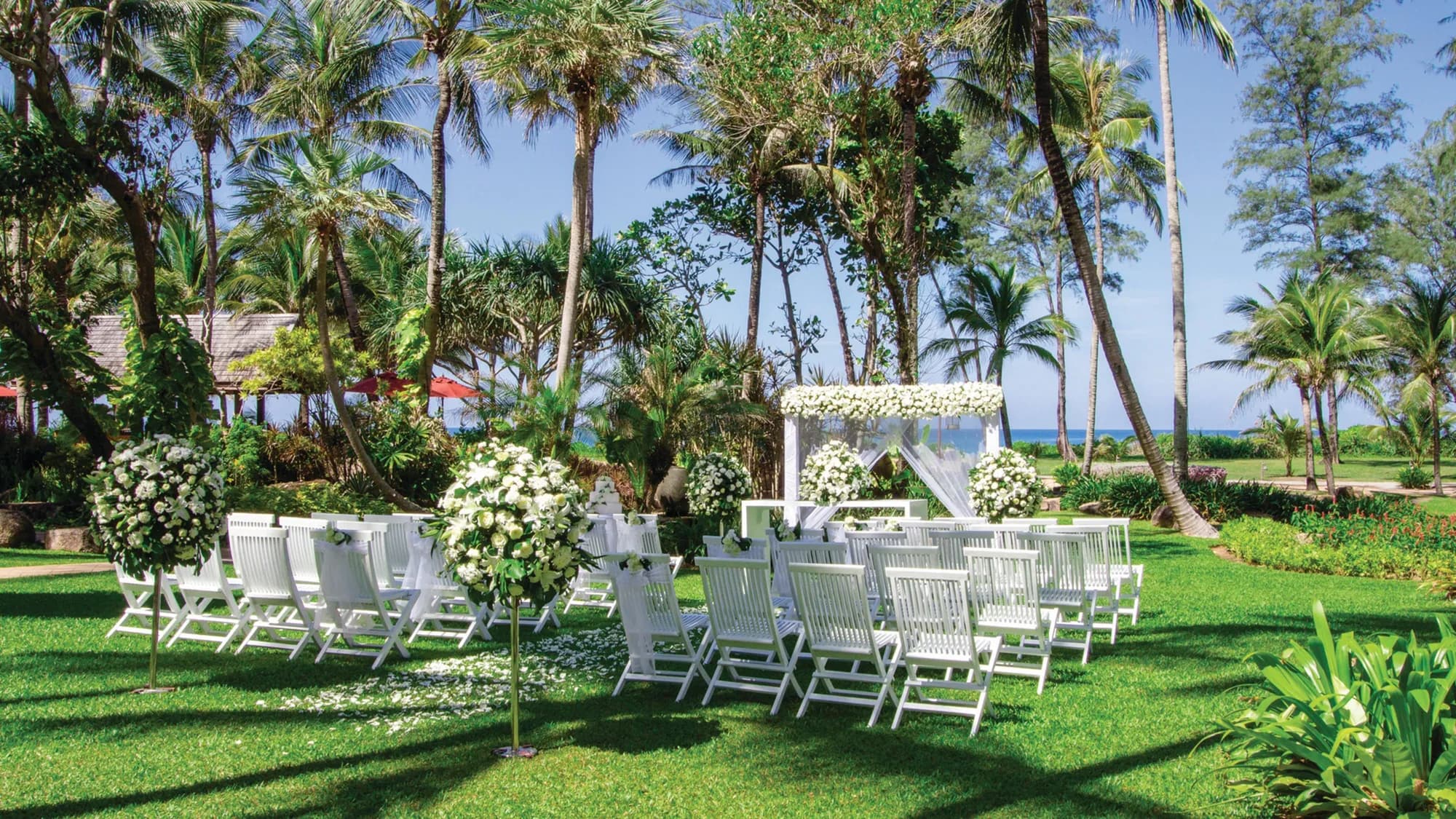 Outdoor wedding reception table setup on the resort grounds at JW Marriott Phuket Resort & Spa