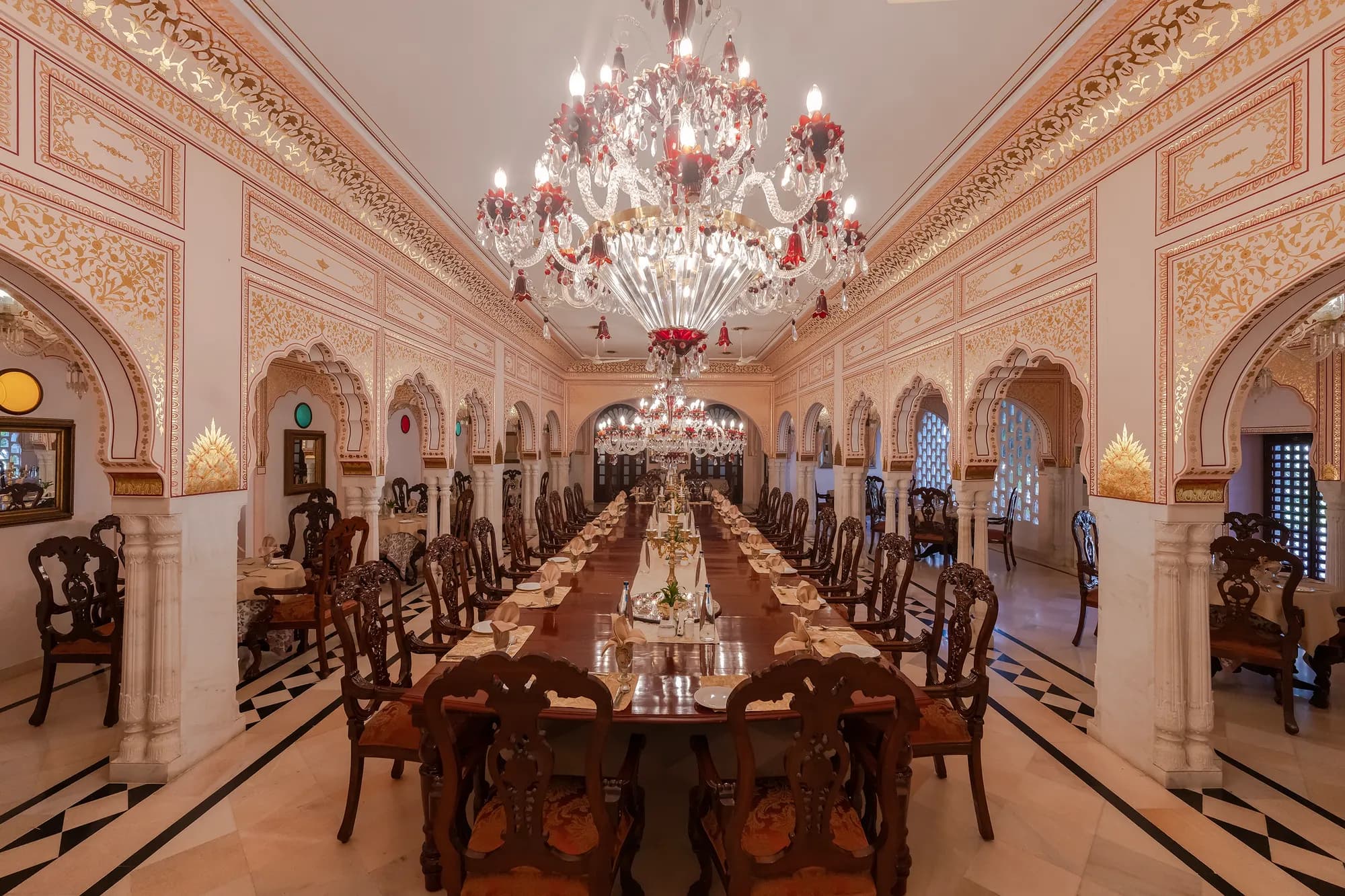 Nahargarh Ranthambhore palace-style hotel facade with carved sandstone gateways and domes at the edge of Ranthambore National Park