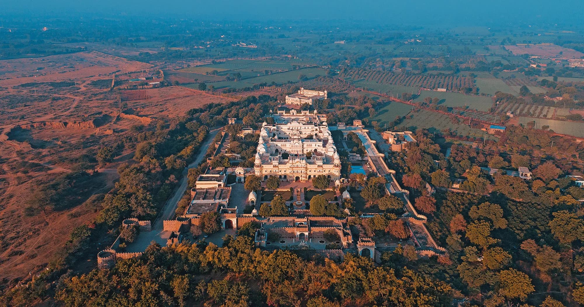Carved sandstone palace-style facade and domes of Nahargarh Ranthambhore at the edge of the National Park