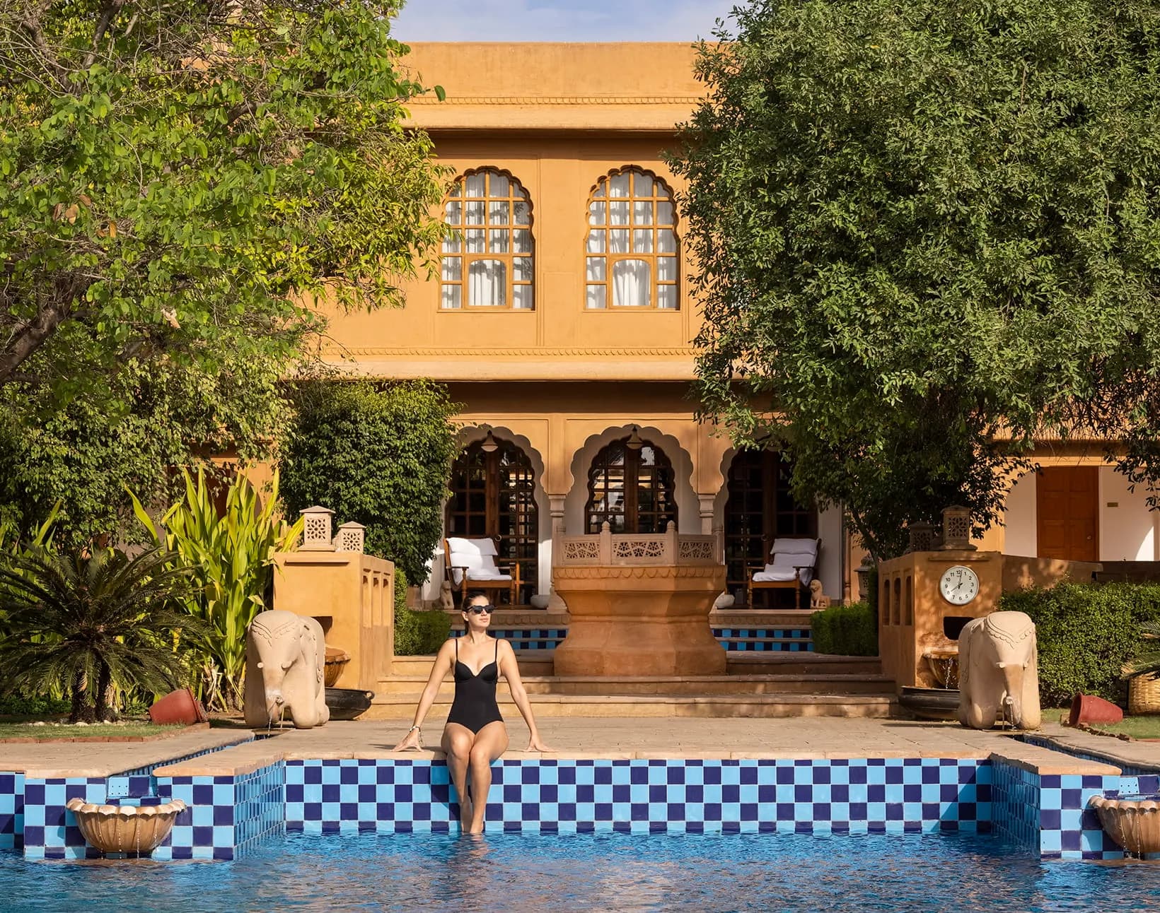 Poolside evening sangeet setting against reflection pools at The Oberoi Rajvilas Jaipur