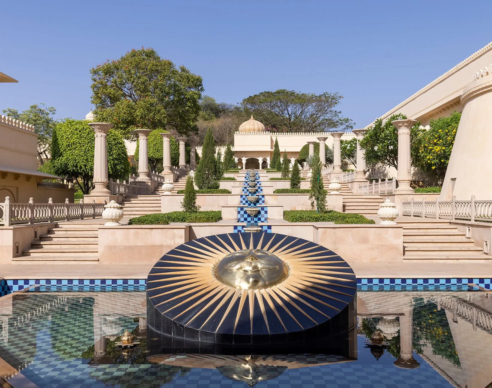 Poolside evening sangeet setting against lit palace domes at The Oberoi Udaivilas Udaipur