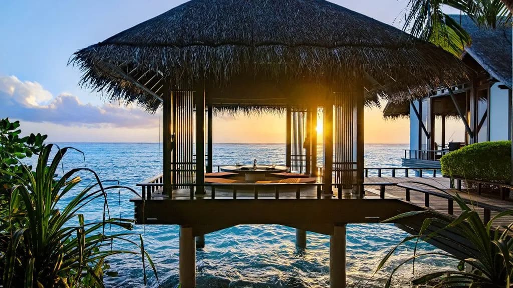 Tapasake over-water dining pavilion at One&Only Reethi Rah at dusk, reception setting Maldives