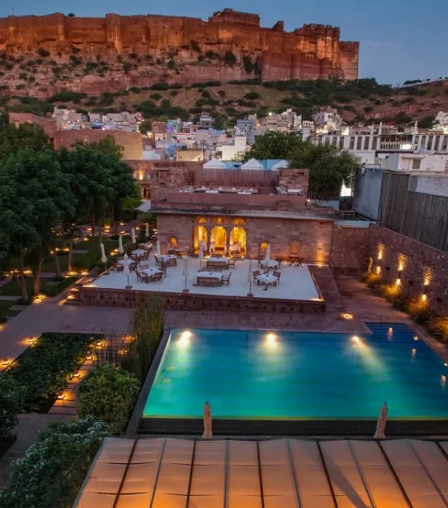 Floodlit Mehrangarh Fort over the blue rooftops of Jodhpur seen from RAAS Jodhpur