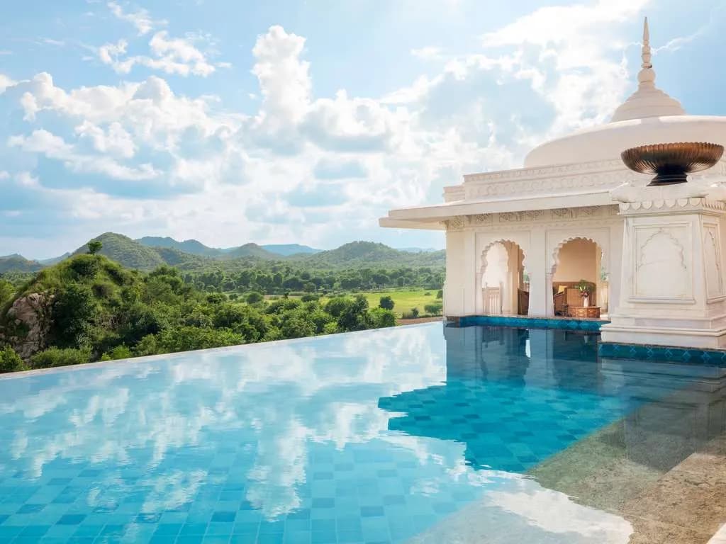 Pool terrace and marble courtyard with Aravalli views at Raffles Jaipur