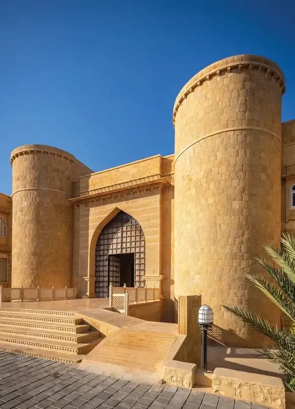 Hotel Rang Mahal golden sandstone heritage-style facade with carved jharokhas in Jaisalmer, the Golden City of the Thar desert
