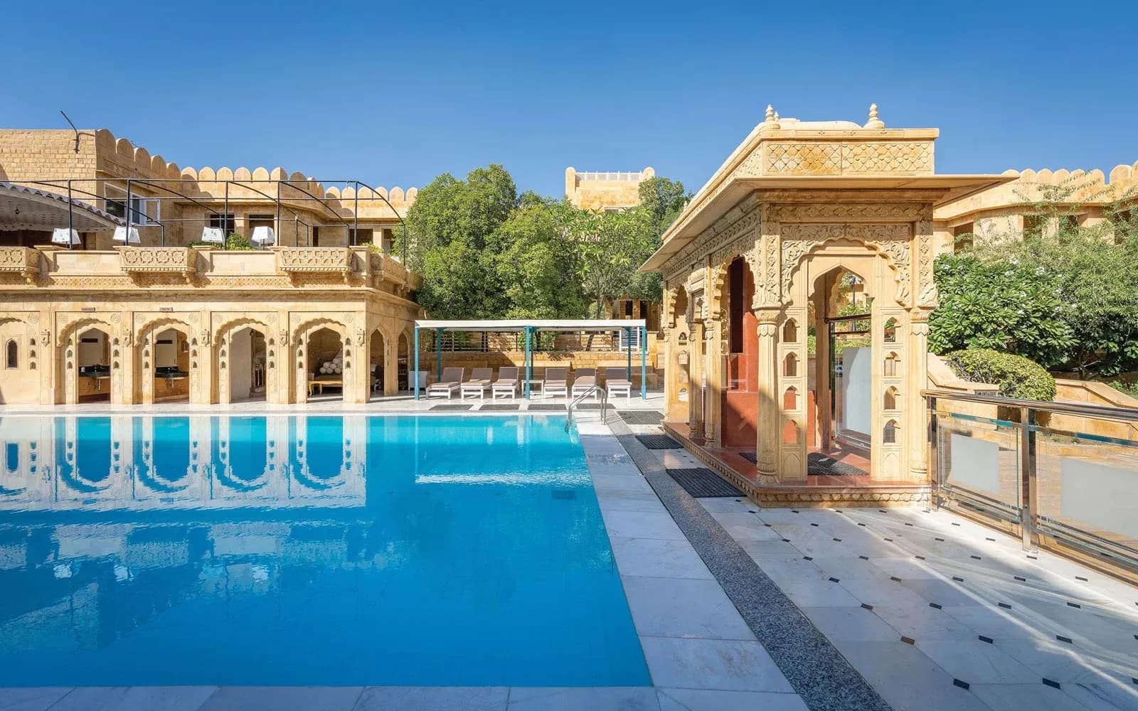 Lit poolside venue and central golden-sandstone courtyard at Hotel Rang Mahal, Jaisalmer
