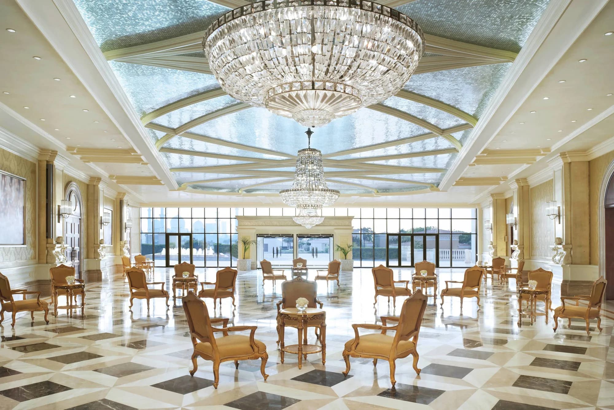Grand chandelier-lit pre-function reception hall with checkerboard marble floor at The Ritz-Carlton Abu Dhabi Grand Canal